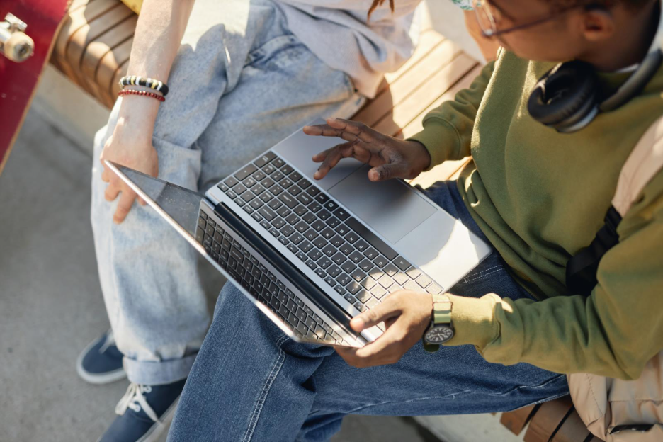 top view of two people around a laptop
